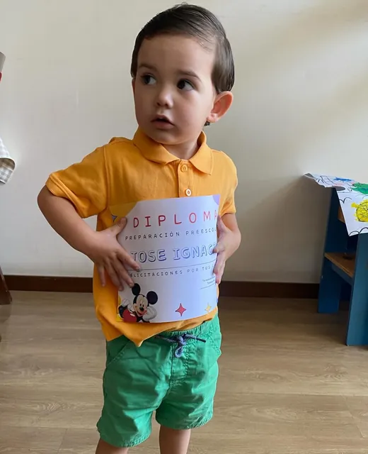 Niño de pie sosteniendo un dibujo